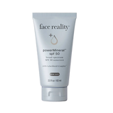 Tube of 'face reality' powerMineral SPF 50 sunscreen on a beige background