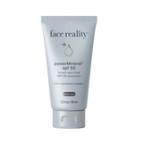 Tube of 'face reality' powerMineral SPF 50 sunscreen on a beige background
